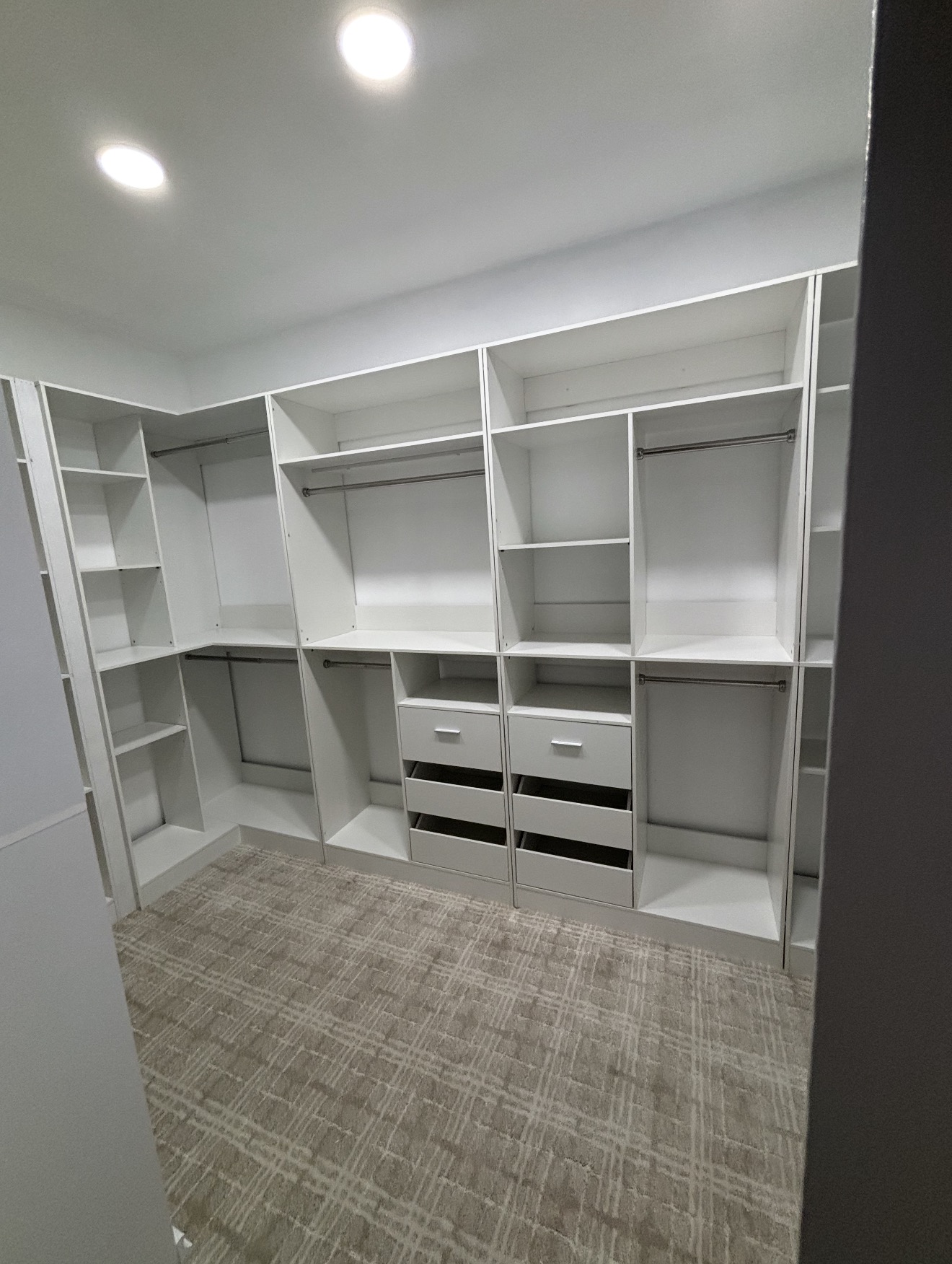 Walk-in master closet with custom white shelving
