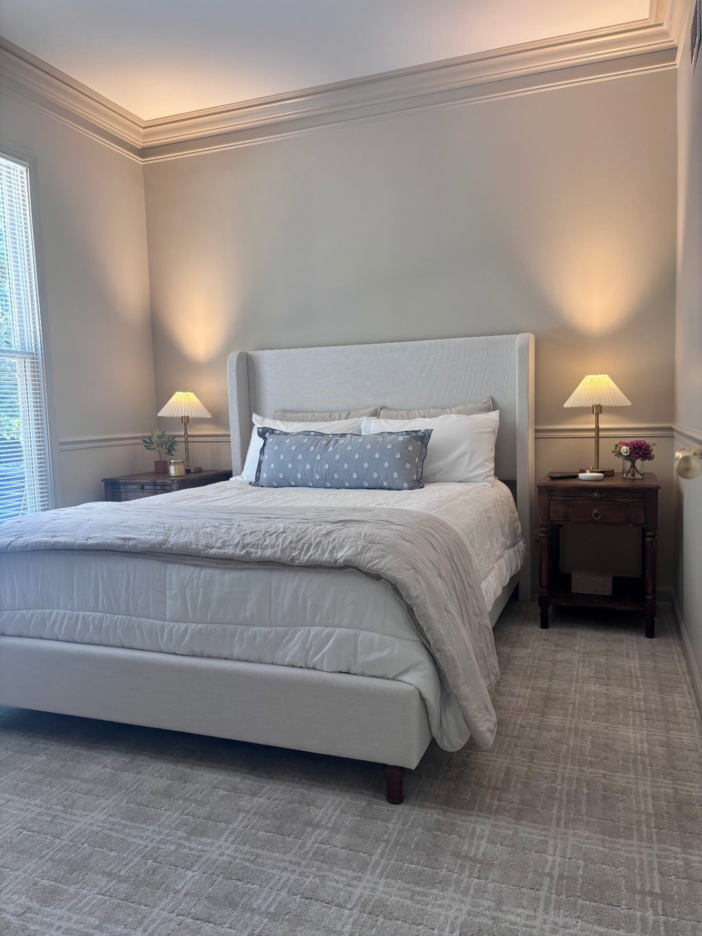 Primary bedroom with upholstered bed and coffered ceiling