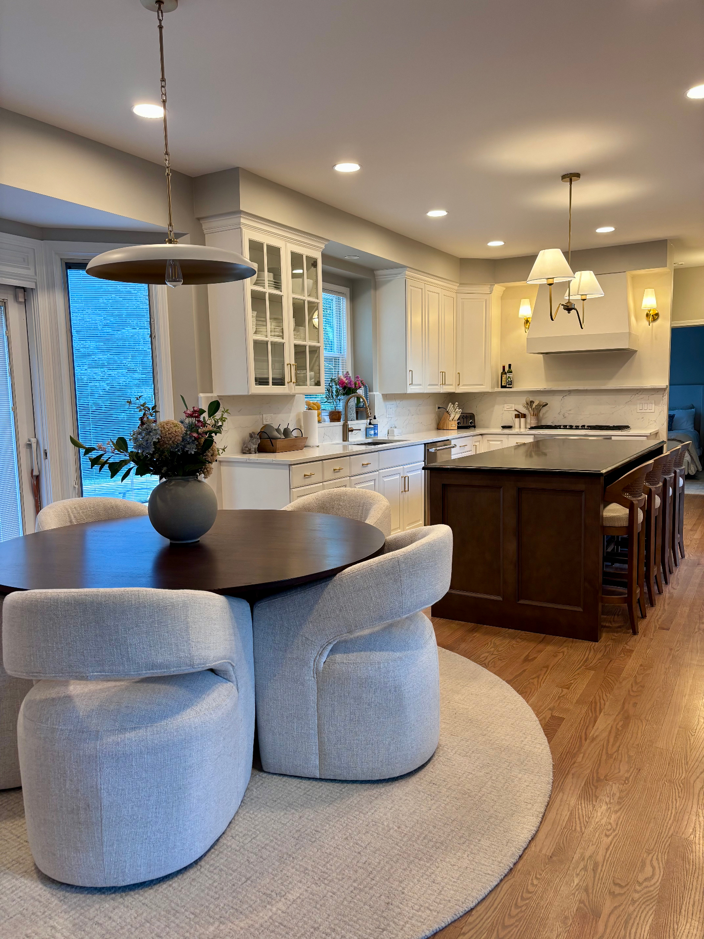 Kitchen and breakfast nook with round table and blue upholstered chairs