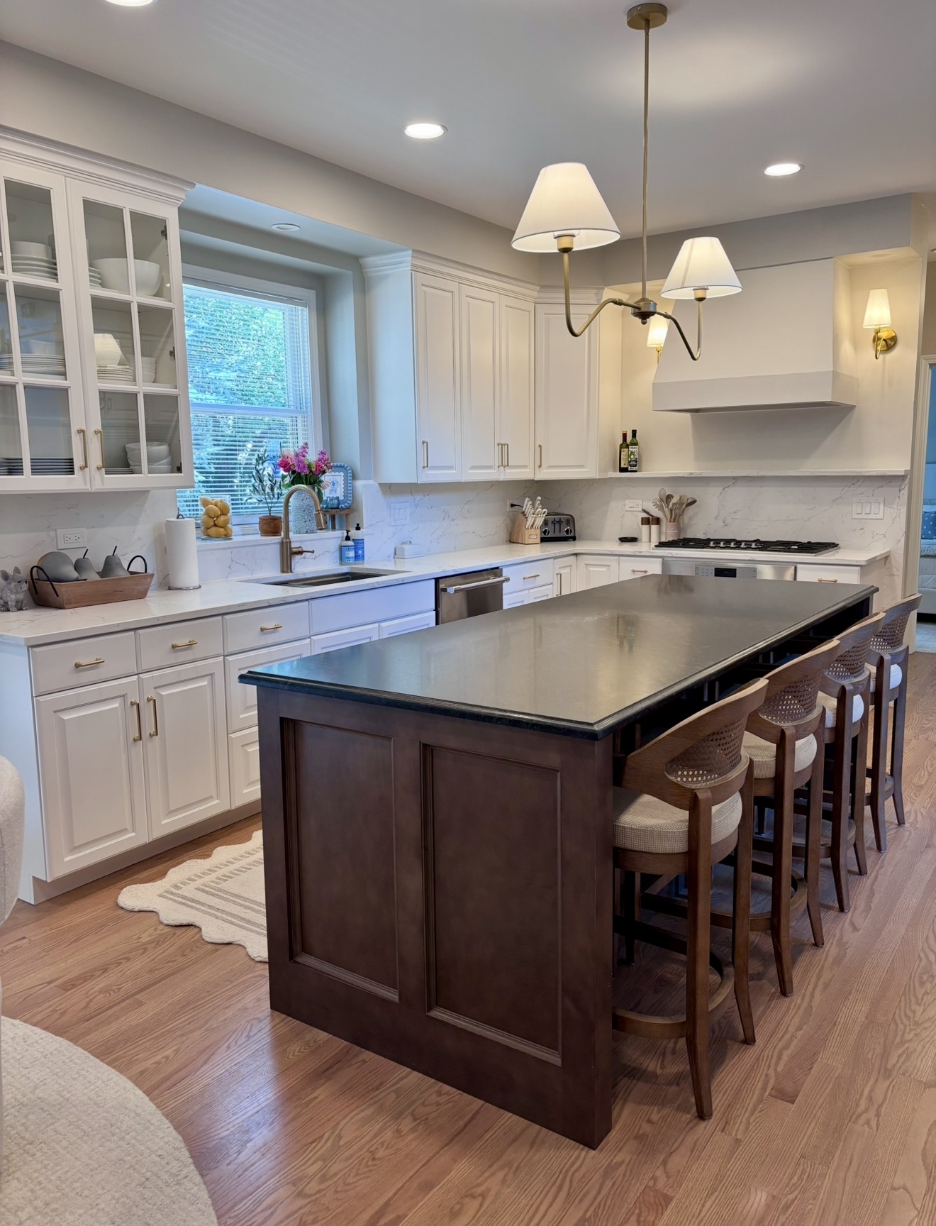 Kitchen with dark stained island and white perimeter cabinetry