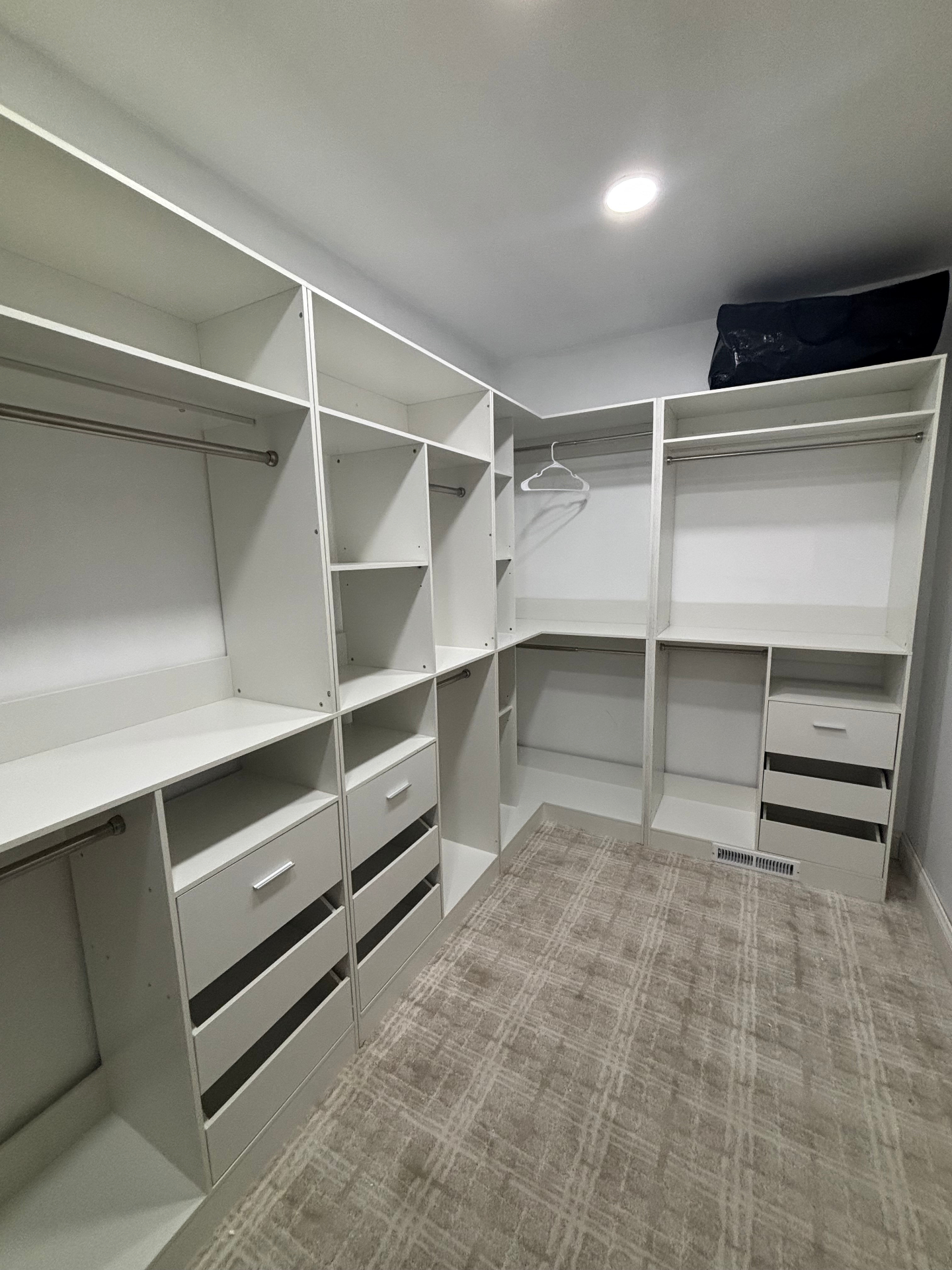 Custom walk-in closet with drawers and hanging rods