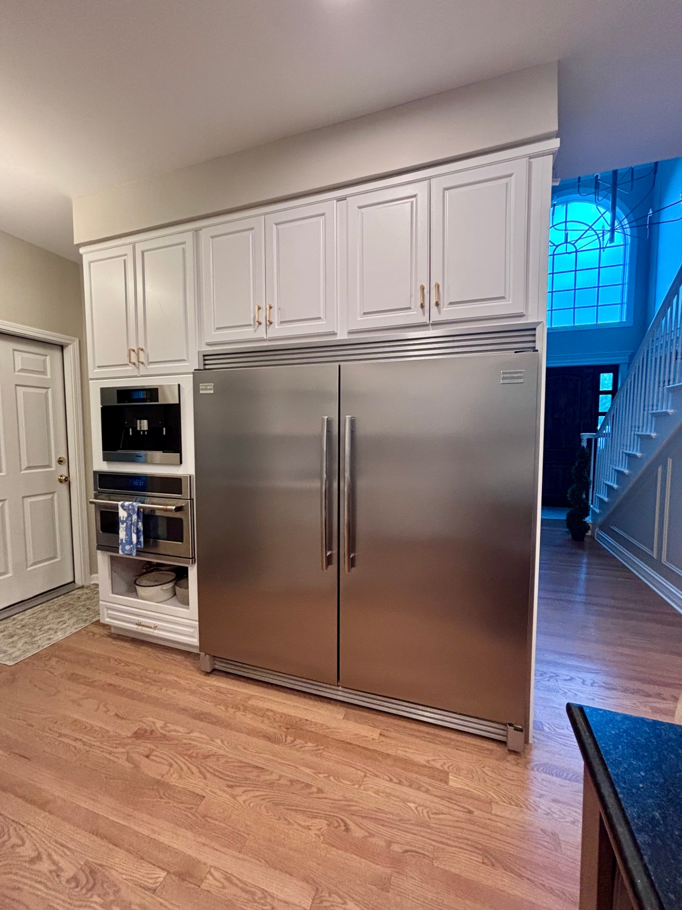Kitchen with full-size double refrigerator and custom cabinetry