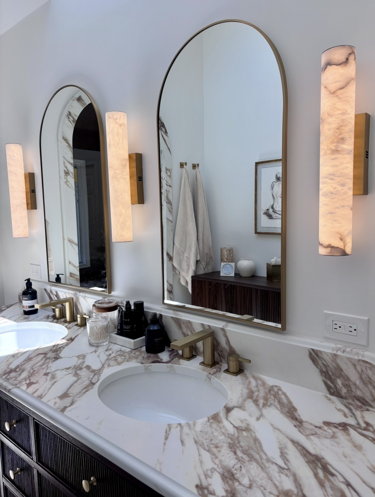 Master bath detail with alabaster sconces and calacatta marble